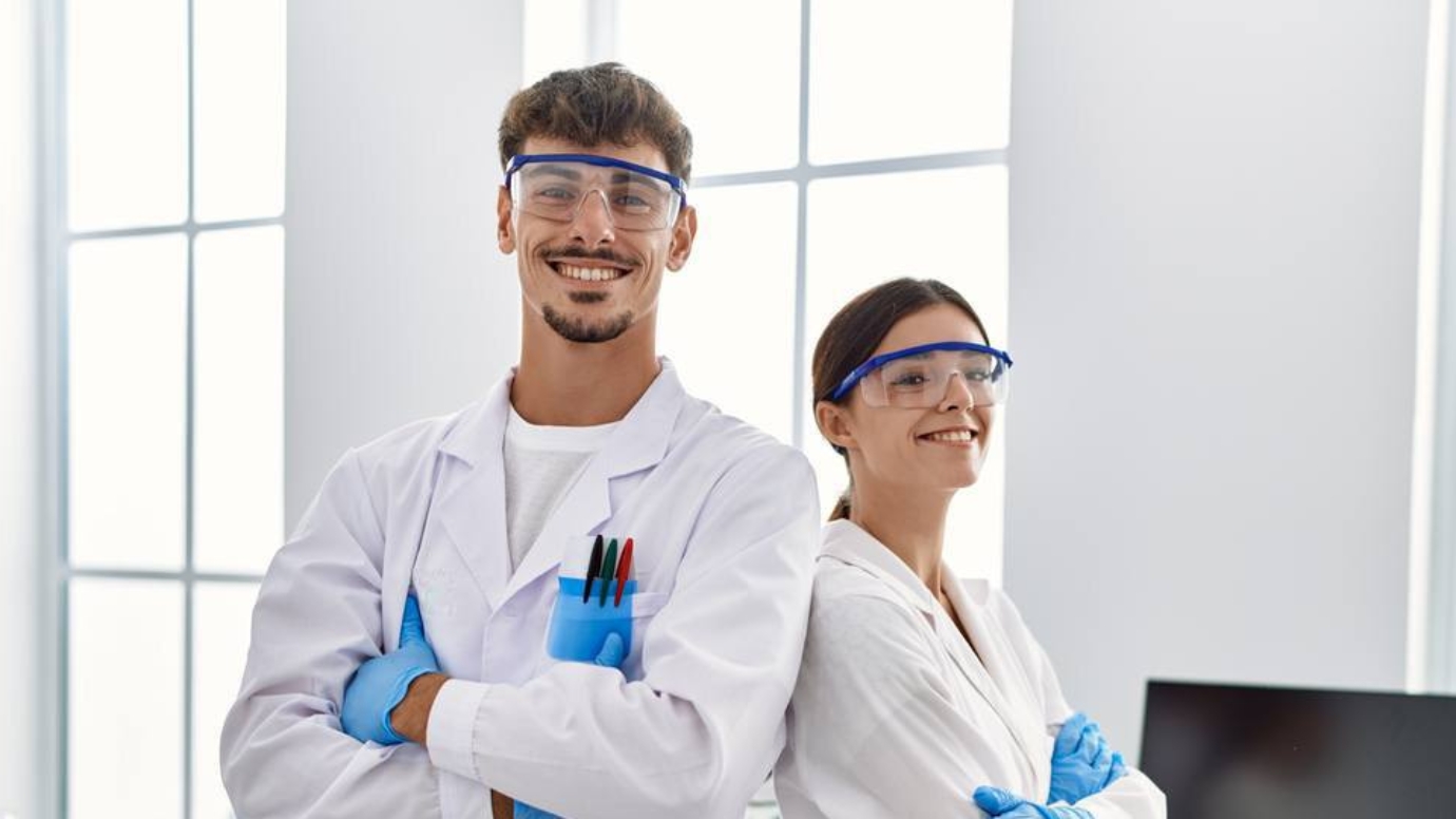 Two researchers wearing protective lab gear